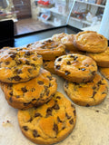 Large homemade Jumbo Chocolate Chip Cookie from Newcastle Bakery with gooey chocolate chips and a golden-brown crust.