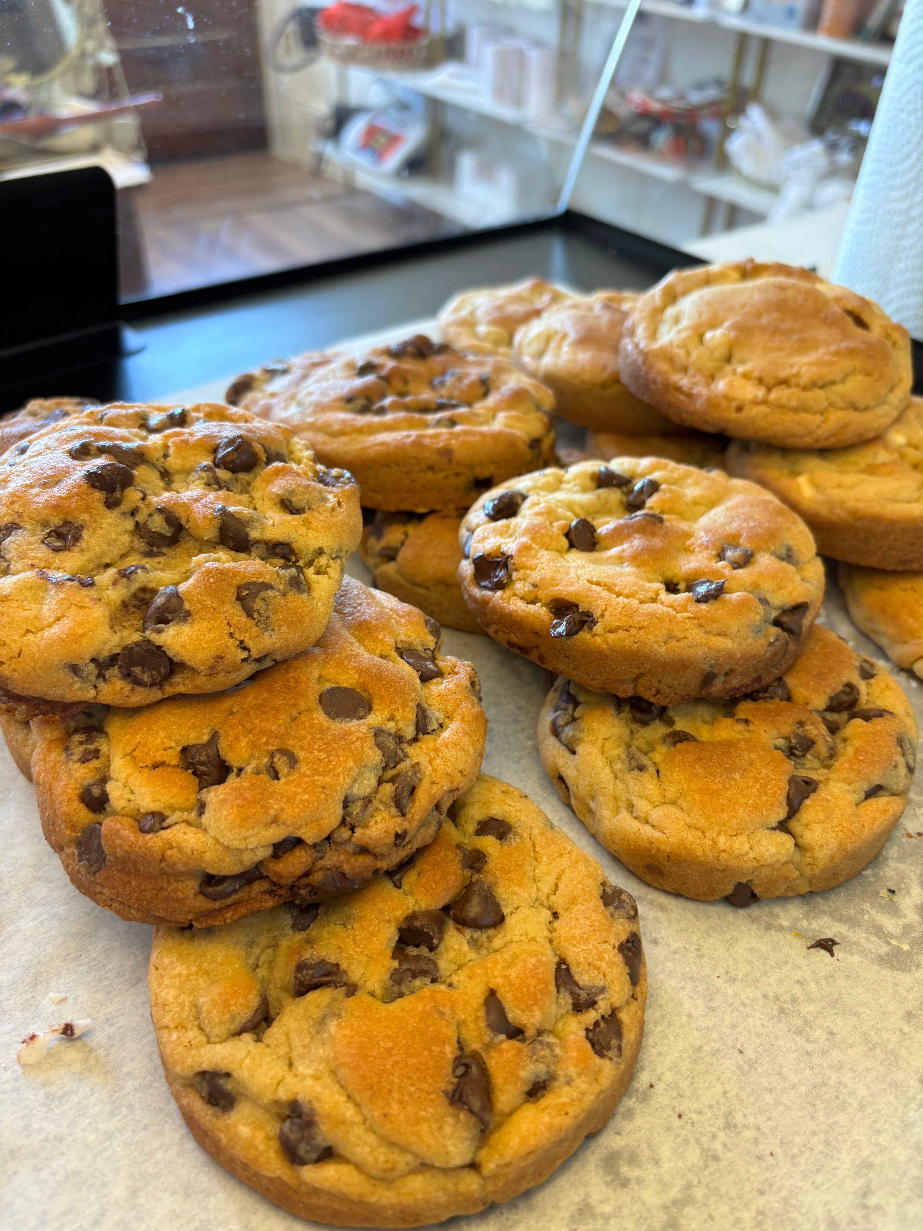 Large homemade Jumbo Chocolate Chip Cookie from Newcastle Bakery with gooey chocolate chips and a golden-brown crust.