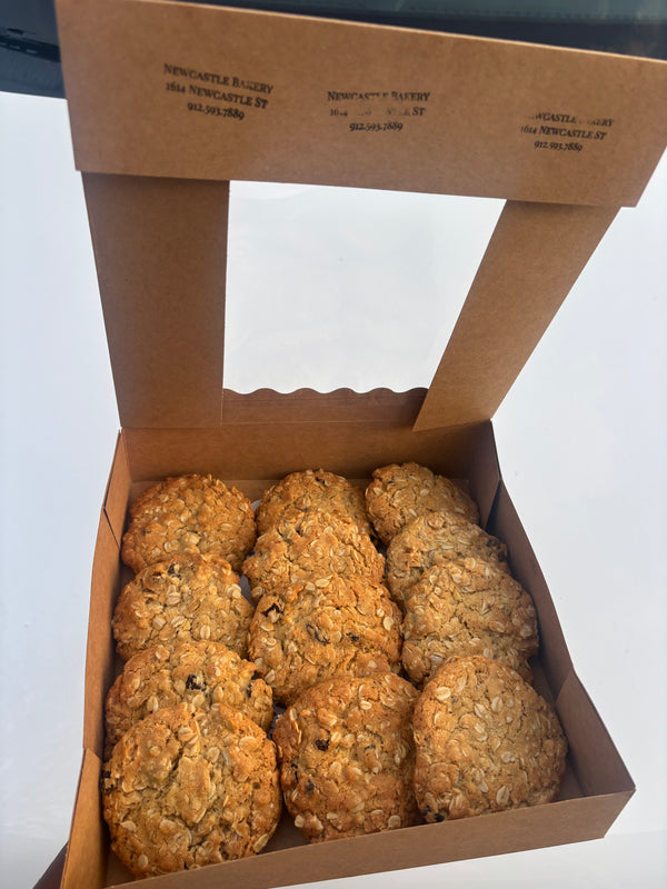 Jumbo brown butter oatmeal raisin cookie from Newcastle Bakery, showing golden-brown surface with visible oats and raisins.